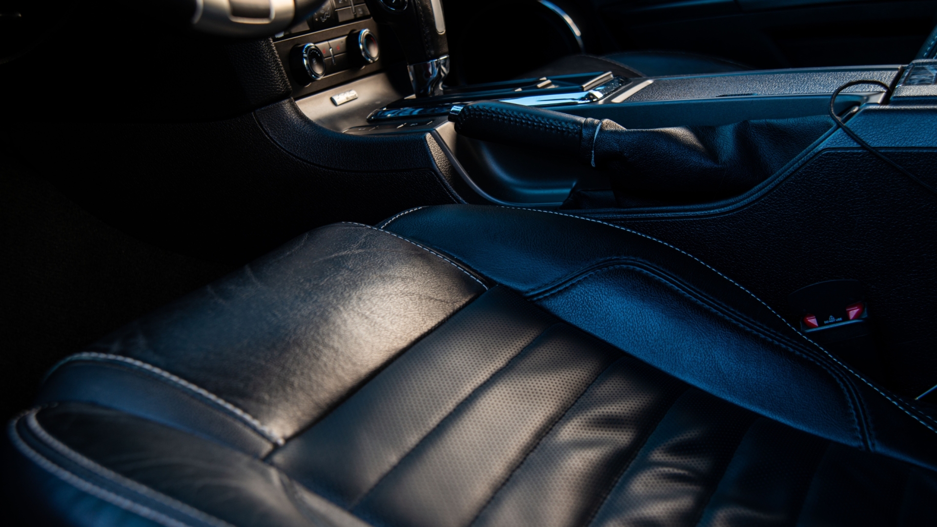 Close-up of a luxurious car interior with leather seating, showcasing style and comfort.