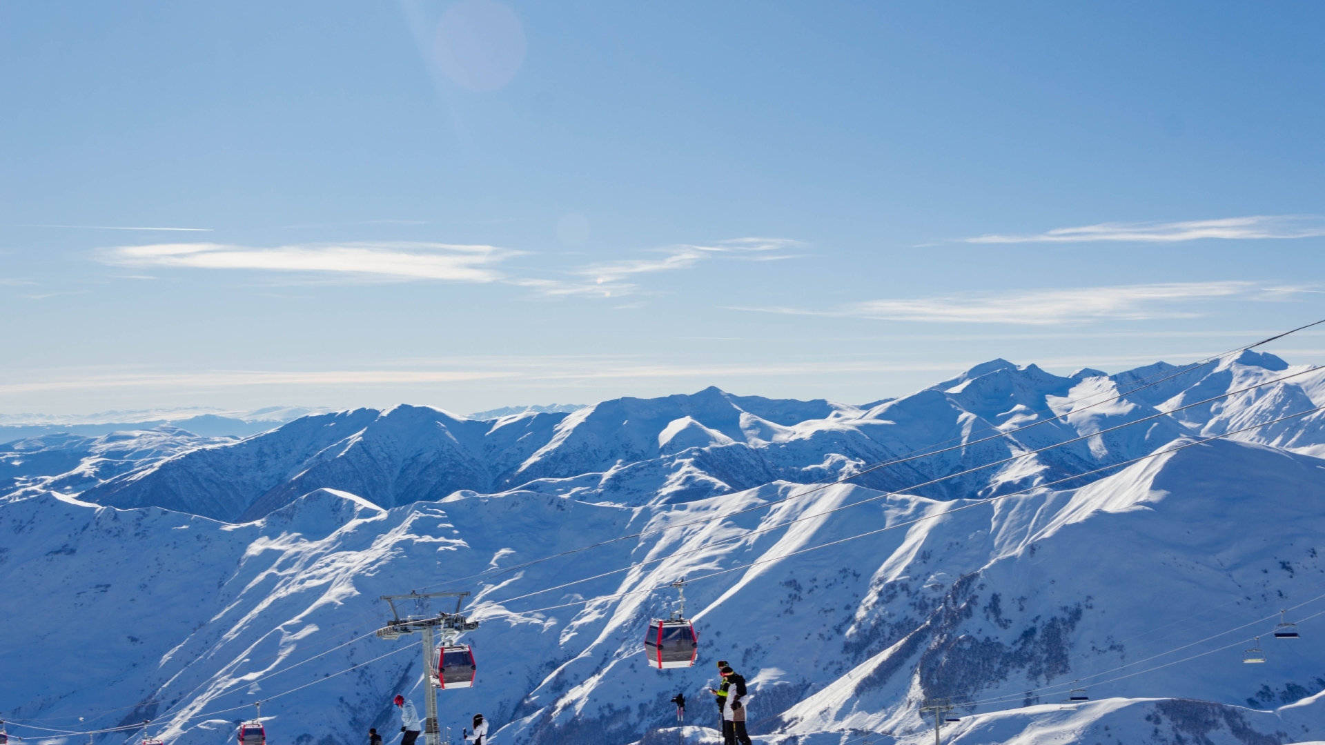 Capture the beauty of Gudauri's snowy peaks and ski lifts against a clear blue sky.